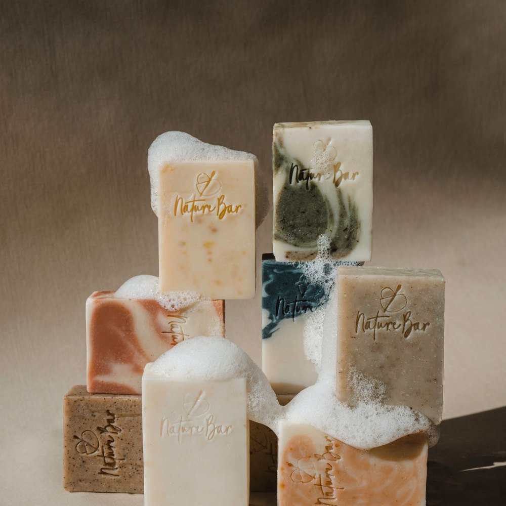 Gentle oatmeal and goat milk bars lathering on a dark background