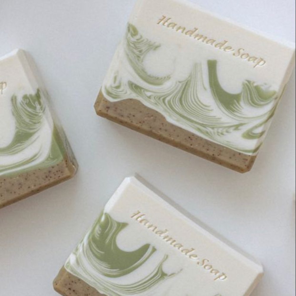 Gentle oatmeal and goat milk bars lathering on a dark background
