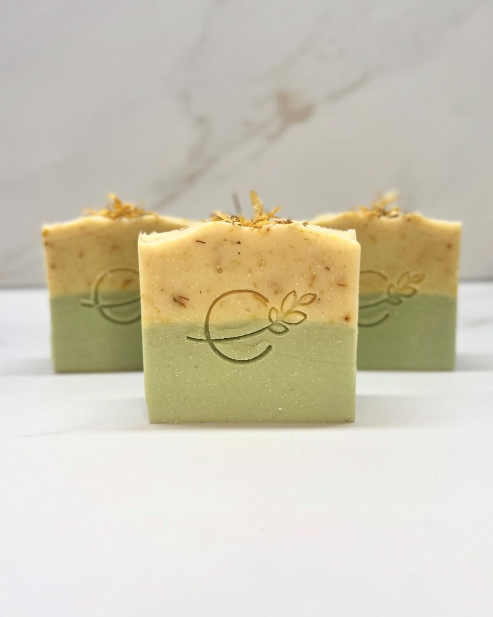 Freshly cut handmade soap bars in cream and sage green
