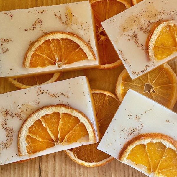 Lemon and poppy seed scrub bars with dried citrus slices on wood